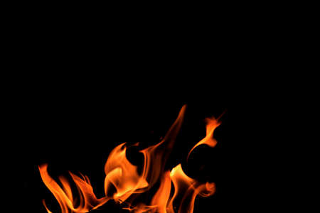 Close up burning flames on black background for graphic design or wallpaper. Red and yellow, heat...