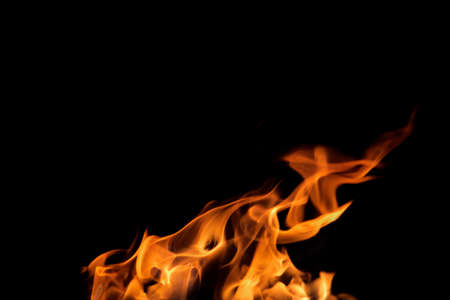 Close up burning flames on black background for graphic design or wallpaper. Red and yellow, heat...