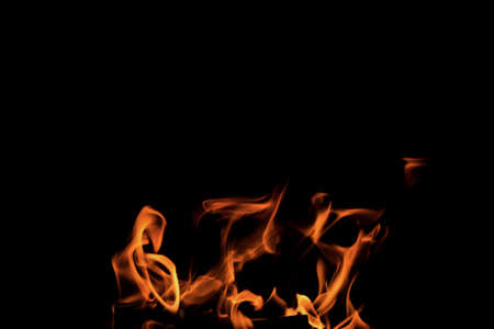 Close up burning flames on black background for graphic design or wallpaper. Red and yellow, heat...