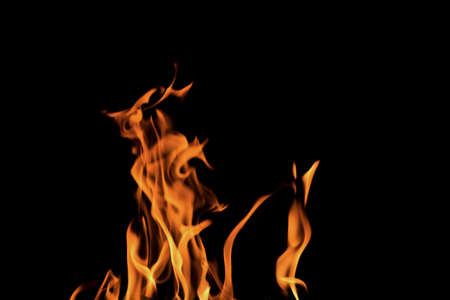 Close up burning flames on black background for graphic design or wallpaper. Red and yellow, heat...