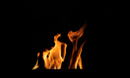 Close up burning flames on black background for graphic design or wallpaper. Red and yellow, heat...