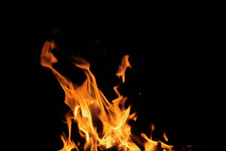 Close up burning flames on black background for graphic design or wallpaper. Red and yellow, heat...