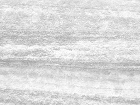 Rough white stone wall background in vintage style for graphic design or wallpaper. Pattern of soft nature floor in retro concept. Gray abstract texture detail in construction or exterior decoration.の写真素材