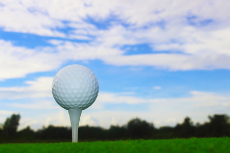 golf ball on tee in a beautiful golf course with morning sunshine.Ready for golf in the first short.Sports that people around the world play during the holidays for health.の写真素材