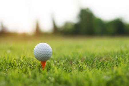 golf ball on tee in a beautiful golf course with morning sunshine.Ready for golf in the first short.Sports that people around the world play during the holidays for health.の写真素材