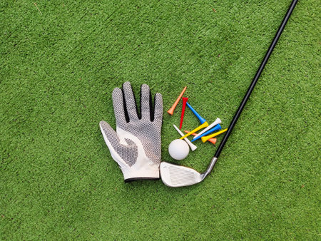 Golf equipment on green grass. Golf balls,tee and golf clubs in the top view for graphic design. Sports that people around the world play during the holidays for health.の写真素材