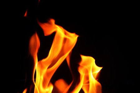 Close up burning flames on black background for graphic design or wallpaper. Red and yellow, heat...