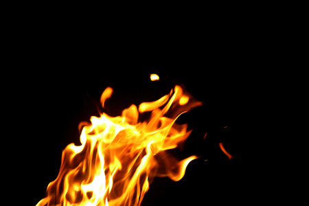 Close up burning flames on black background for graphic design or wallpaper. Red and yellow, heat...