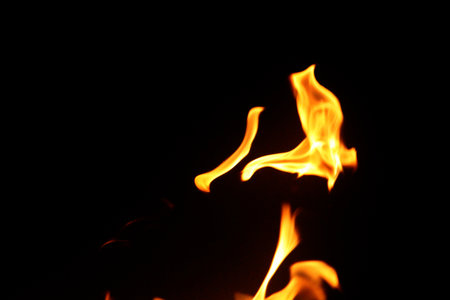 Close up burning flames on black background for graphic design or wallpaper. Red and yellow, heat...