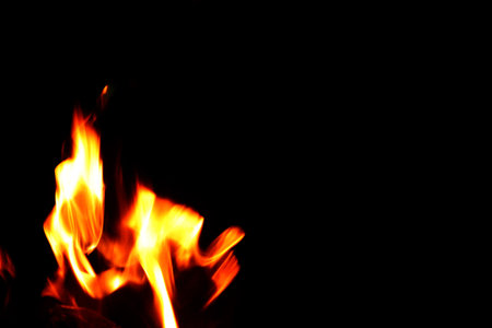 Close up burning flames on black background for graphic design or wallpaper. Red and yellow, heat...