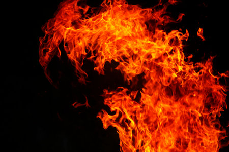 Close up burning flames on black background for graphic design or wallpaper. Red and yellow, heat...