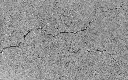 Cracked concrete wall texture, Cement background not painted in vintage style for graphic design or retro wallpaper.の写真素材