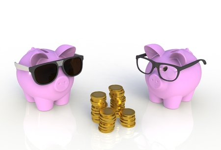 Pink piggy bank with coins isolated on whiteの写真素材