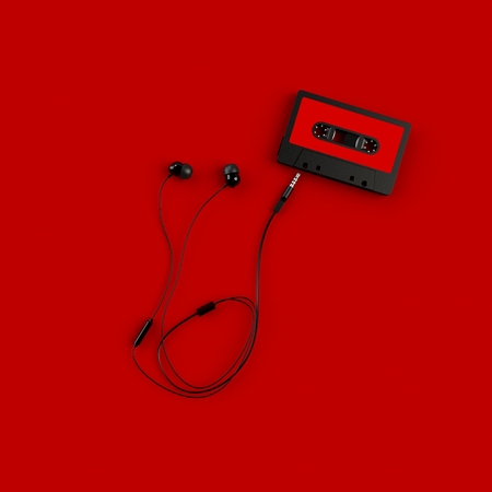 Close up of vintage audio tape cassette with head phone concept illustration on red background, Top view with copy space, 3d renderingの写真素材