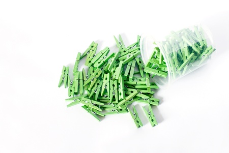 Green clothes-pegs scatter  on  white floor.の写真素材