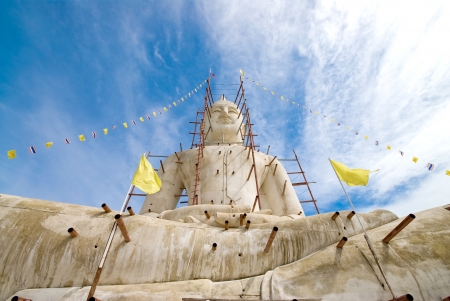 Buddha statue with blue sky and clouds under constructionの写真素材