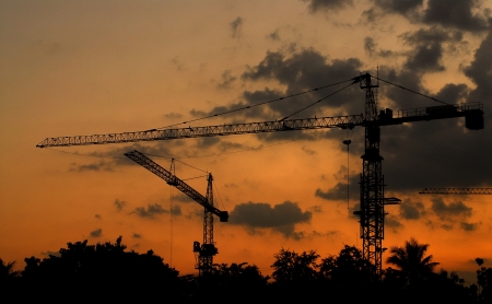 tower cranes on a sunset backgroundの写真素材