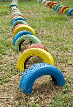 old  tires with colorful paint on a playgroundの写真素材