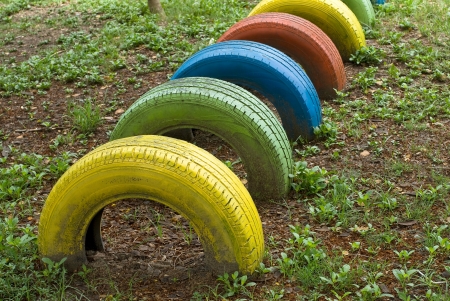 old  tires with colorful paint on a playgroundの写真素材