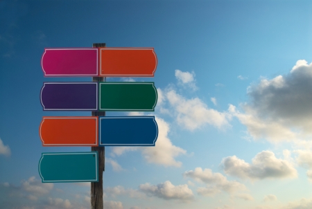 colorful signs on blue sky with clouds