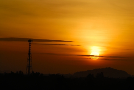 golden sky with telecommunication towerの写真素材