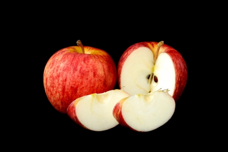 red apple and piece on  black backgroundの写真素材