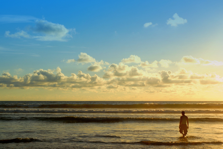silhouette of man on the beach in eveningの写真素材