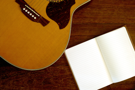 note paper with acoustic guitar on wooden floorの写真素材