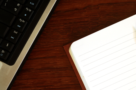 Note paper and computer keyboard on old wooden floor 