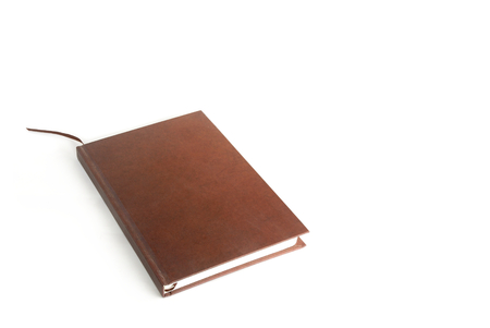 Brown  notebook on white background.の写真素材