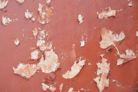 Cement wall with brown color paint and peeling.