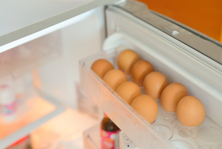 Chicken eggs on a shelf of the refrigerator.の写真素材