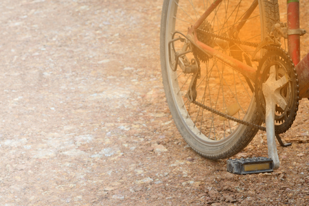 Bicycle wheel on a dirt road. Focus on transmission gear part.の写真素材