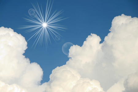 White clouds with sun rays on blue sky.の写真素材