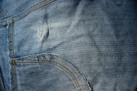 Denim texture with seam, blue jean seam inside. Closeup for background.