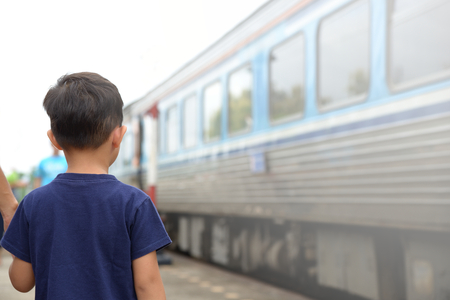 Boy waiting for the train on platform. To enhance the experience of traveling and learning new things.の写真素材