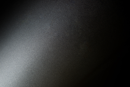 Texture of dark grey and light on surface of metal plate. Closeup for background.の写真素材