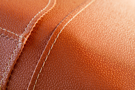 Orange leather with white stitch closeup for background.Part of leather motorcycle seat.の写真素材