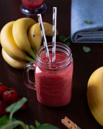 Fresh strawberry banana smoothie on the tableの写真素材