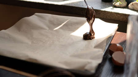 dough for delicious brownie cake on dark wooden table next to ingredients and cooking utensils, top view.の写真素材