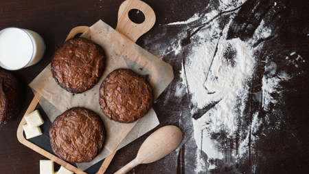 An overhead photo of chocolate chips cookies, shot from above on a piece of baking paper, with copy spaceの写真素材