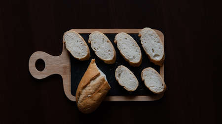 Fresh baguette slices on a cutting boardの写真素材
