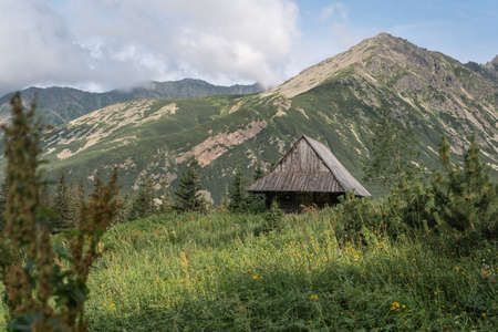 old wooden hut cabin in mountain alps at rural fall landscapeの写真素材