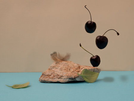 Sweet cherries for dessert balancing flying from a teaspoon isolated on white backgroundの写真素材