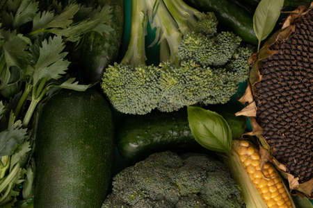 Green vegetables on wooden background peas, parsley, basil, cucumber, dill, onion ,saladの写真素材