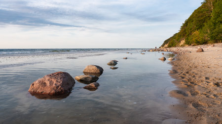 Beautiful seascape. Wild rocky sandy seashell beach. A small cozy bay.