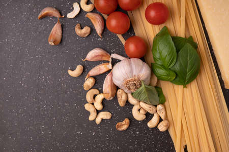 Pasta pesto. ingredients for Green vegetarian sauce pesto with basil, parmesan, nuts and olive oil. mediterranean traditional pastaの写真素材