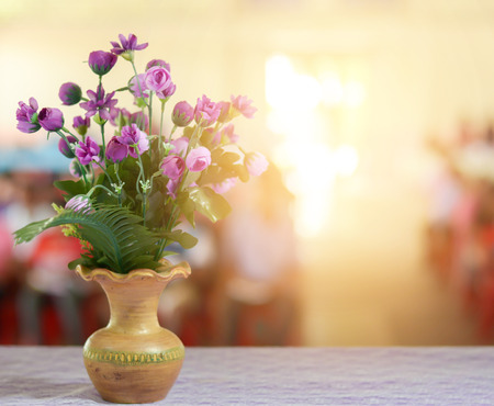 Artificial flowers in a vase on a table in the meeting room.の写真素材