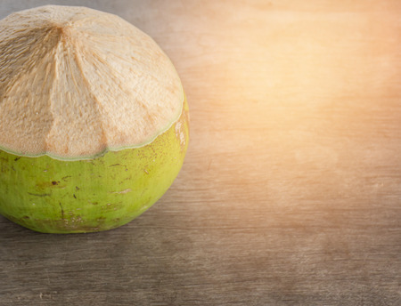 Coconut cluster on woodbackground.Coconut on wood background.fresh coconut.coconut juice.Juice in...