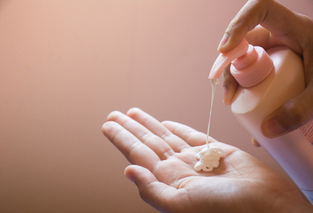 Hands of women pressing cream on the palm to moisturize their own skin to be healthy. Concept of health and beauty.の写真素材